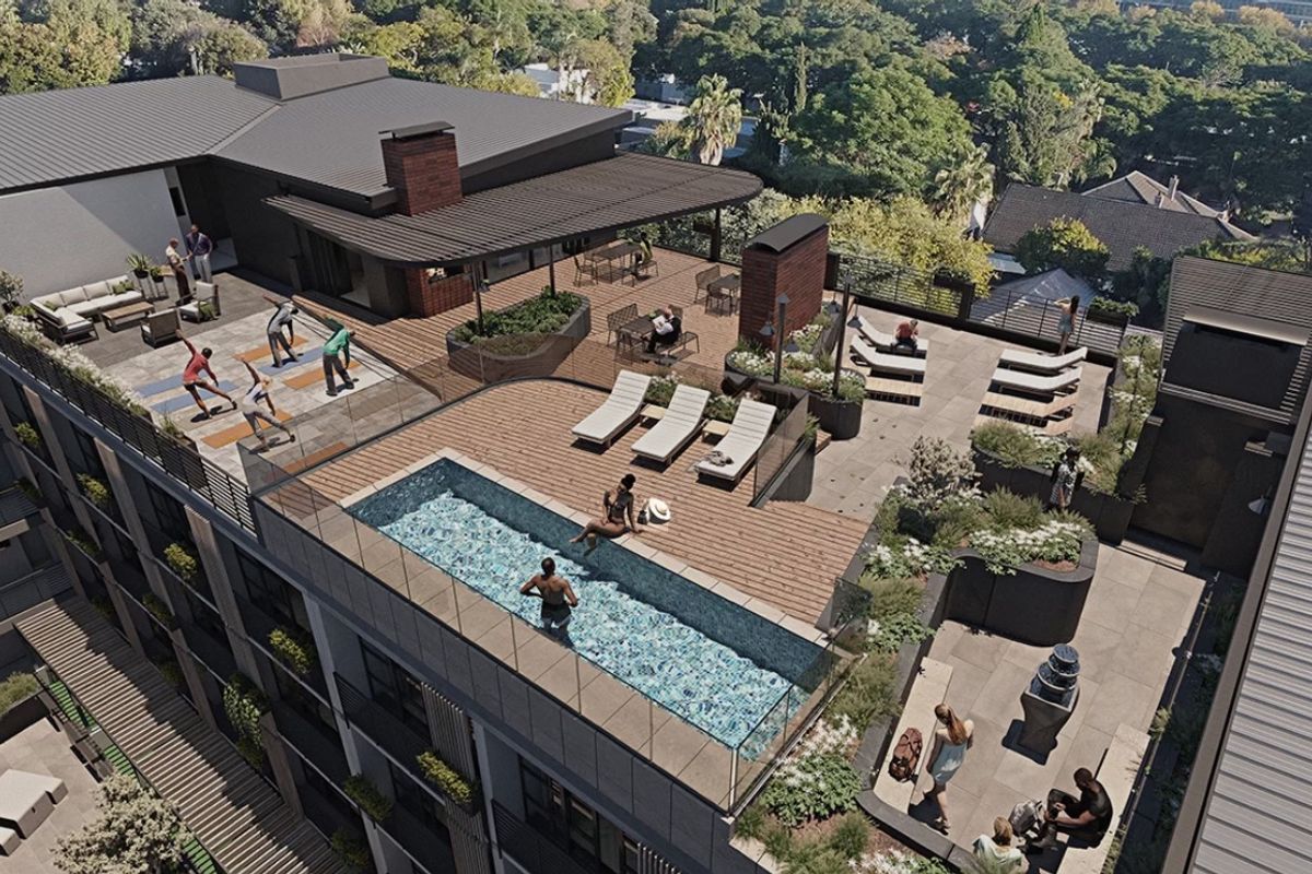 An elevated rooftop terrace featuring a swimming pool, glass balustrades, timber decking, and landscaped planters with views over the surrounding area.