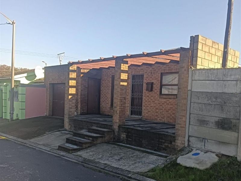 Front elevation of a face brick house featuring a timber pergola, concrete entrance steps, and a secure garage entrance.