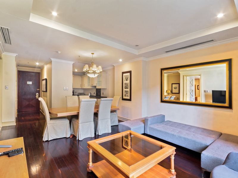 Spacious open-plan living and dining area featuring dark hardwood flooring, recessed ceiling lighting, and integrated ducted air conditioning.