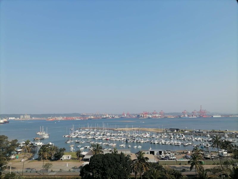 Elevated panoramic view overlooking the marina, harbor, and industrial port area.