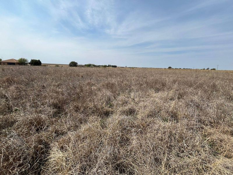 Expansive open landscape view across the farm property, showcasing the natural terrain and surrounding rural environment.