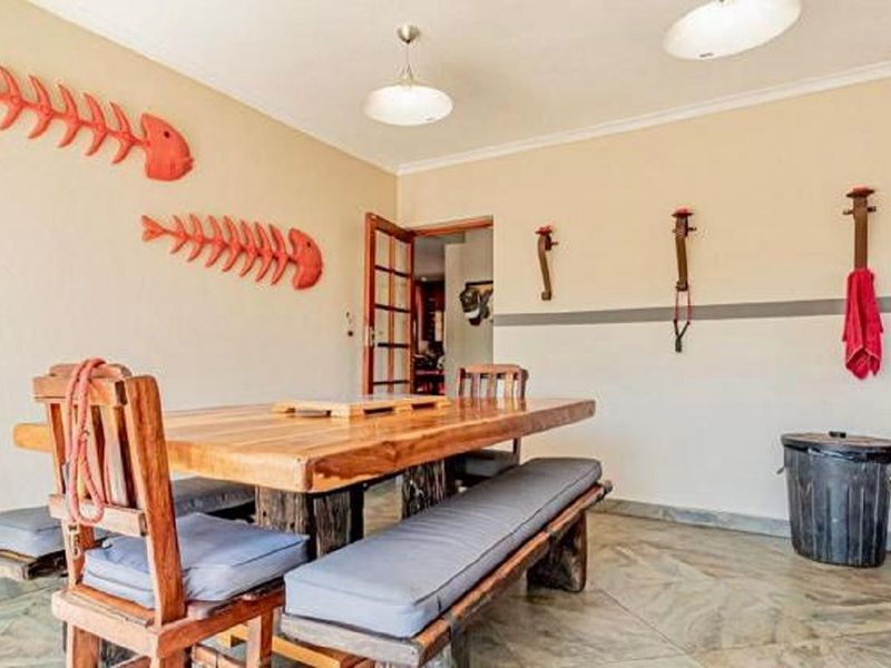 A dining area featuring tiled flooring and neutral wall finishes, providing a functional space for family meals.