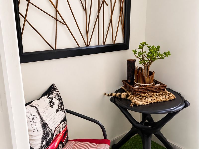 A small indoor balcony or nook area featuring artificial grass flooring and a decorative wall-mounted frame.