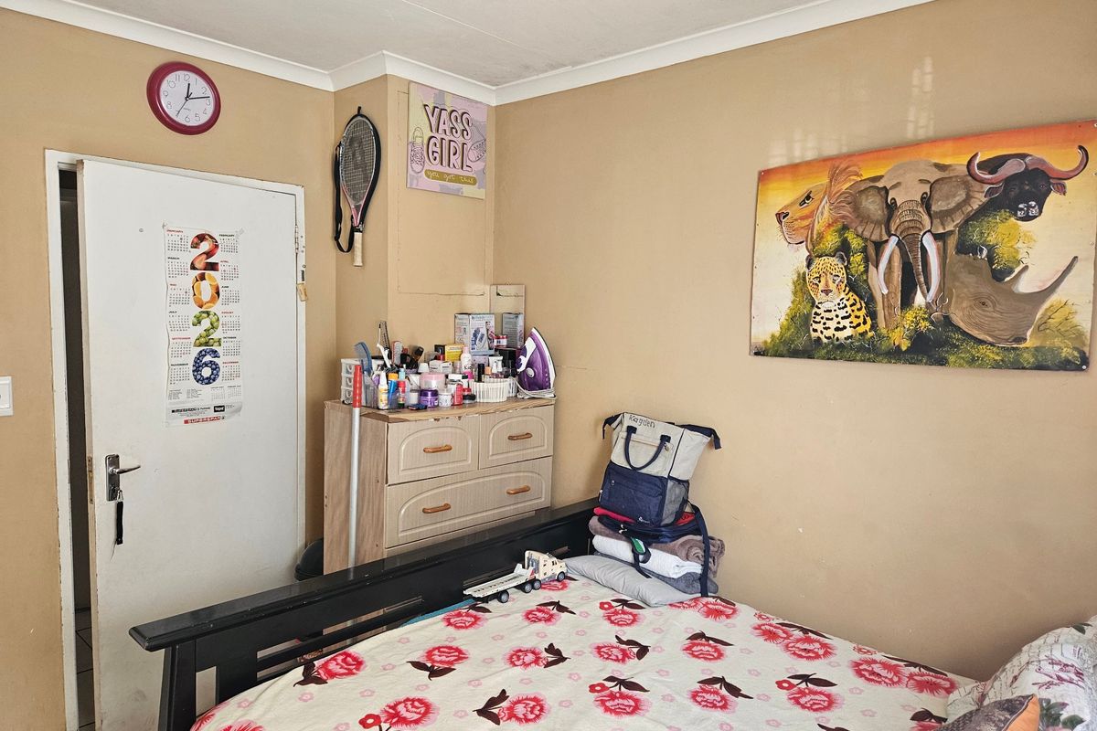 A standard bedroom featuring neutral wall paint and coving, providing a functional space for rest.
