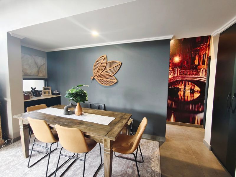 A dining area featuring tiled flooring, recessed ceiling lighting, and decorative wall finishes, providing a functional space for meals and entertaining.
