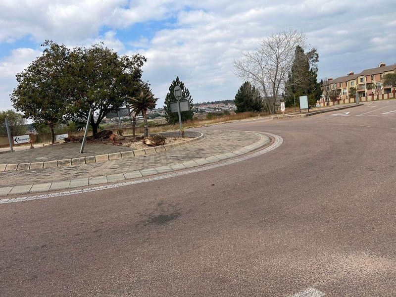 A view of the paved roundabout and access road leading into the residential apartment complex.