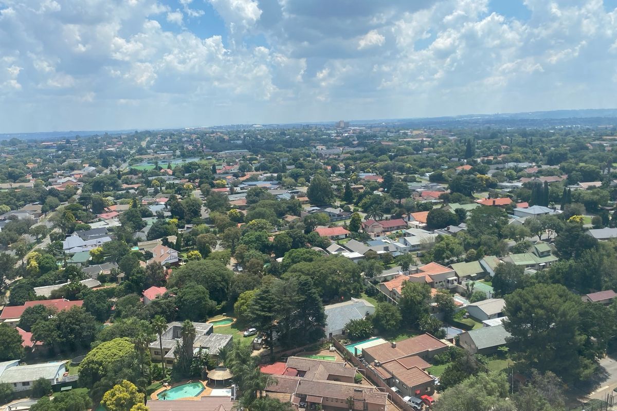 An elevated aerial view showcasing the surrounding residential neighborhood and suburban landscape.