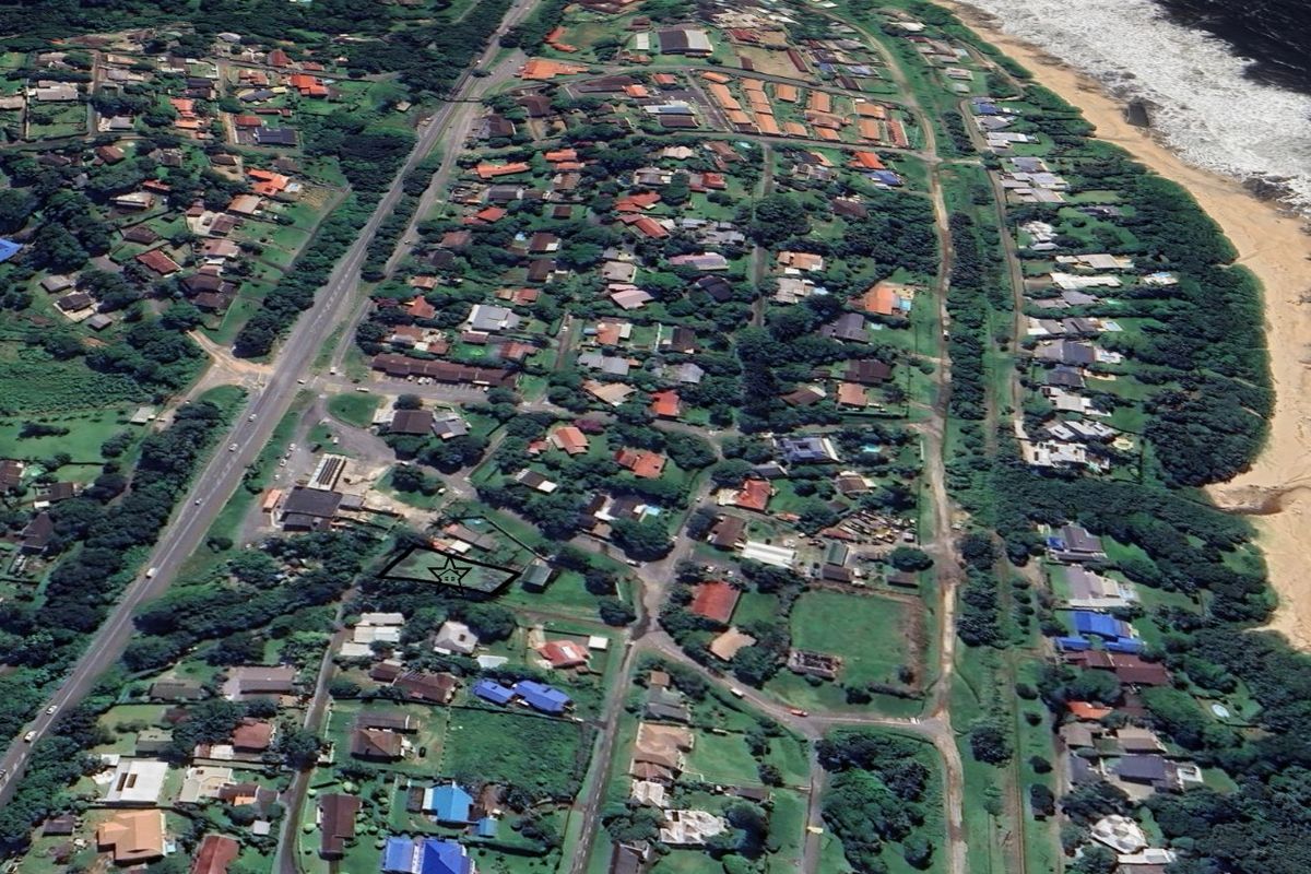An aerial view of a residential neighborhood situated along the coastline, highlighting the property's location within the community.
