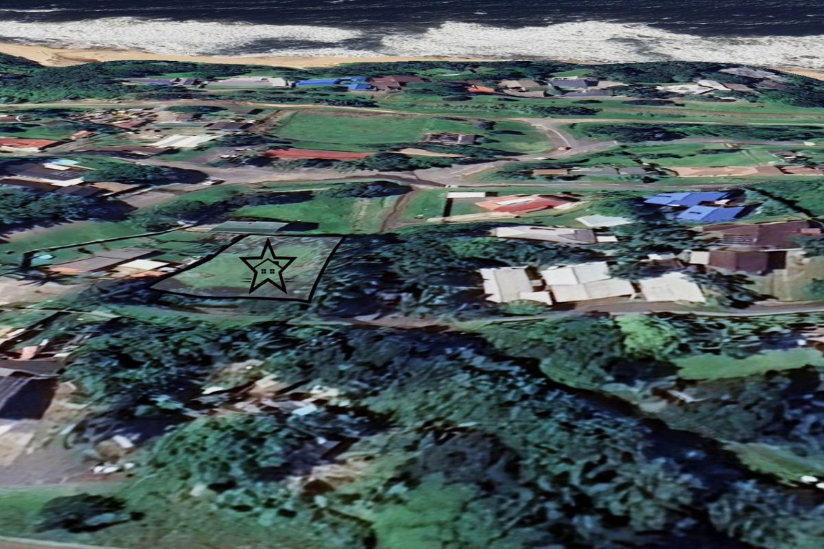 An aerial view of a vacant residential land plot located in a coastal neighborhood, marked with a star for identification.