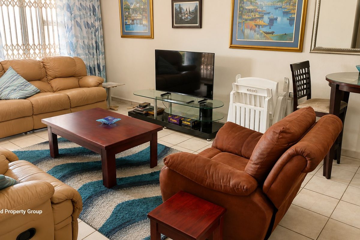 A comfortable living room area featuring tiled flooring and a security gate, providing a functional space for relaxation.