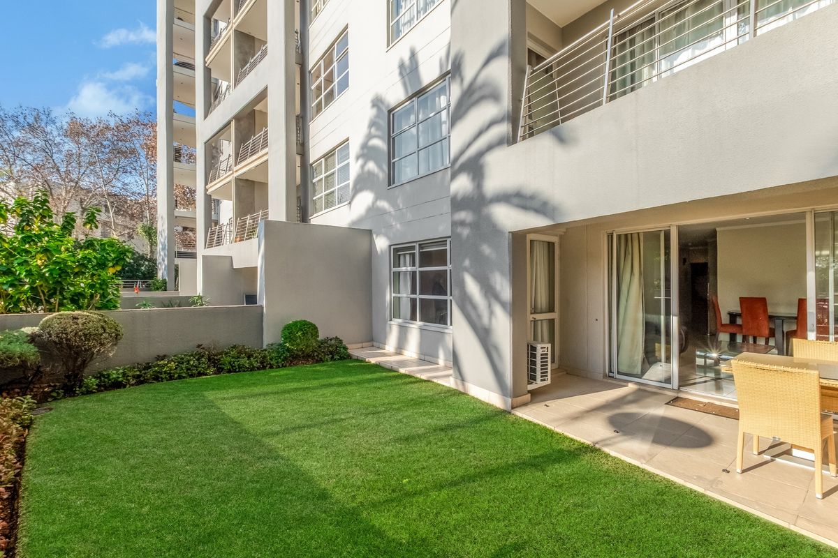 Ground floor apartment featuring a private garden, tiled patio area, and direct access to the living space through sliding glass doors.
