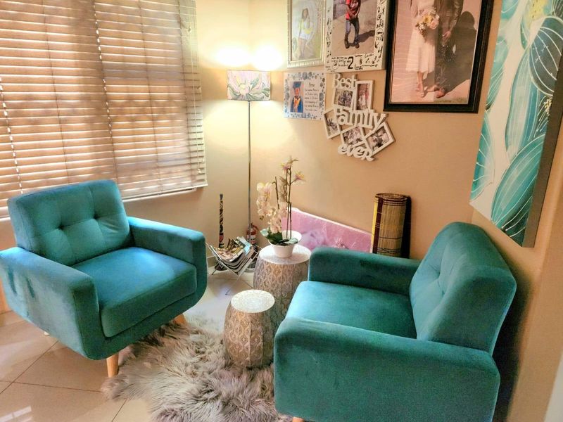 A cozy seating area featuring tiled flooring and venetian blinds, providing a comfortable space for relaxation.