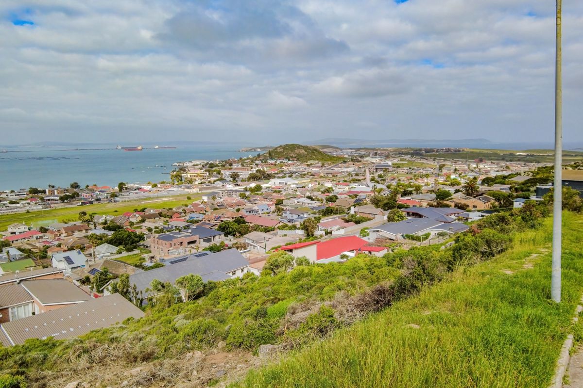 Elevated panoramic view overlooking the coastal residential suburb and bay area.