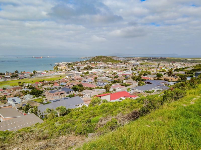 Elevated panoramic view overlooking the coastal residential suburb and bay area.