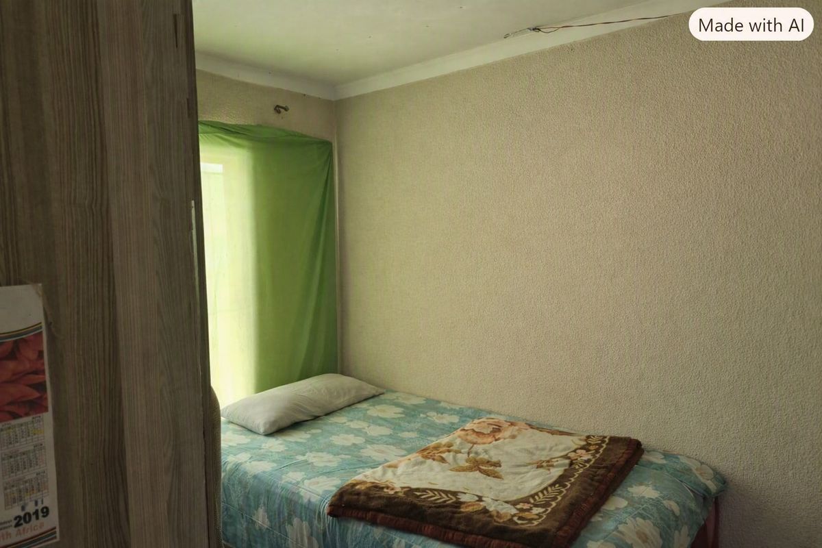 A compact bedroom featuring textured wall finishes and coving, currently requiring maintenance to address exposed wiring and general wear.