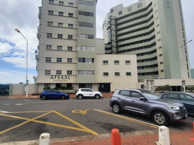 Exterior view of the Afsaal apartment building facade, featuring multi-story residential units and a paved street-level parking area.