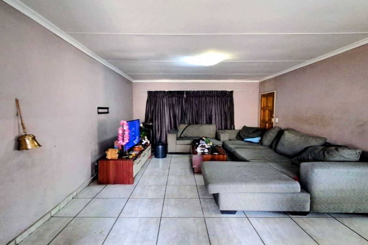 A living room featuring tiled flooring and neutral wall finishes, providing a functional space for relaxation.