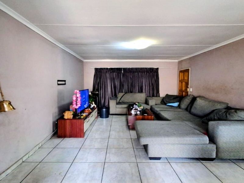 A living room featuring tiled flooring and neutral wall finishes, providing a functional space for relaxation.