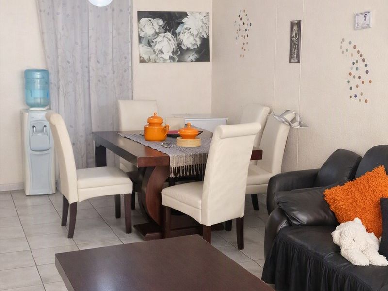 Open plan living and dining area featuring tiled flooring and neutral wall finishes.
