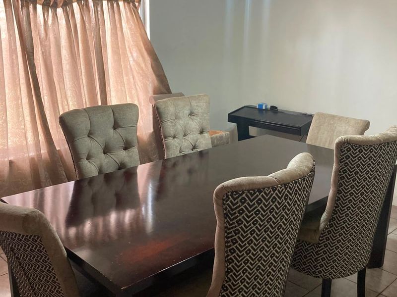 Dining room featuring tiled flooring, a timber ceiling, ceiling fan, and a wall-mounted split-system air conditioner.