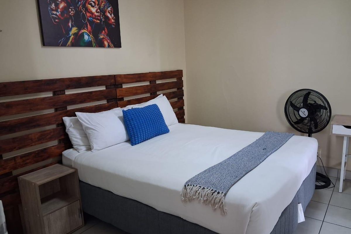A bedroom featuring tiled flooring and neutral wall finishes, providing a functional space for rest.