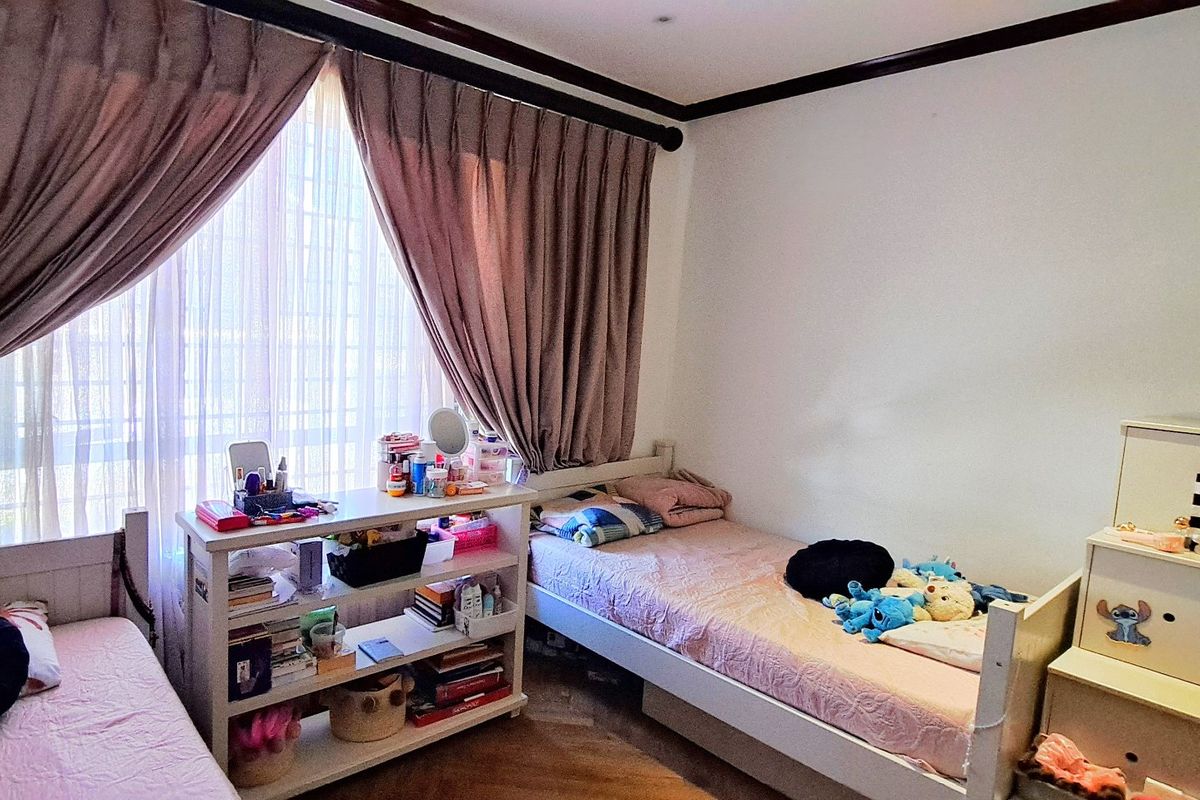 A bedroom featuring large windows with curtains, crown molding, and recessed lighting, providing a functional space with natural light.