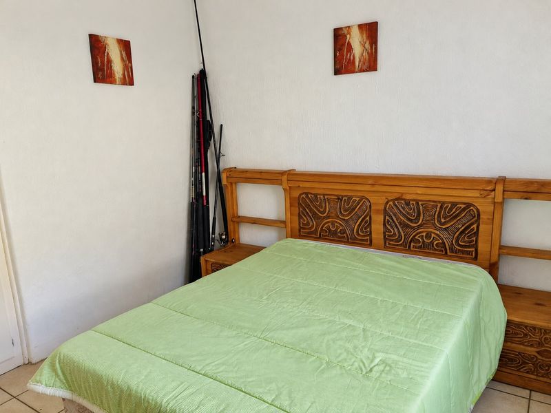 A standard bedroom featuring tiled flooring and white walls, providing a functional space ready for personalization.
