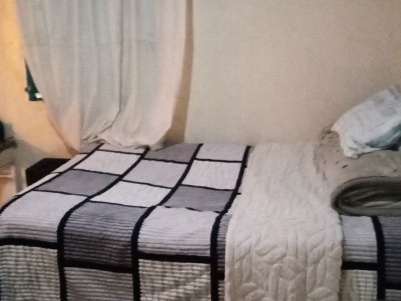 A simple bedroom space with basic finishes, suitable for potential renovation or restyling to enhance its appeal.