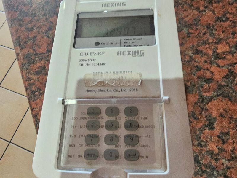 A close-up view of a wall-mounted prepaid electricity meter unit.