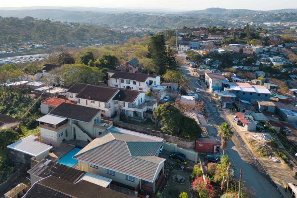 Aerial view of the property showing the residential layout, swimming pool, and surrounding neighbourhood context.