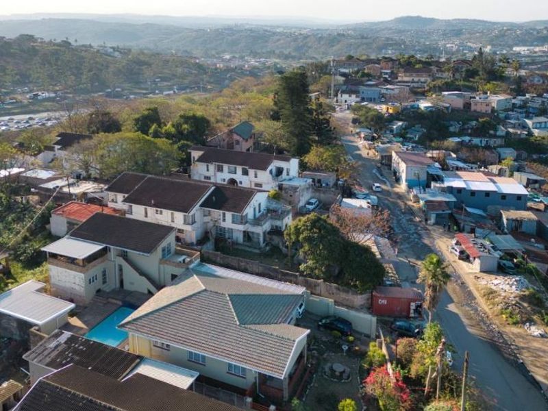 Aerial view of the property showing the residential layout, swimming pool, and surrounding neighbourhood context.