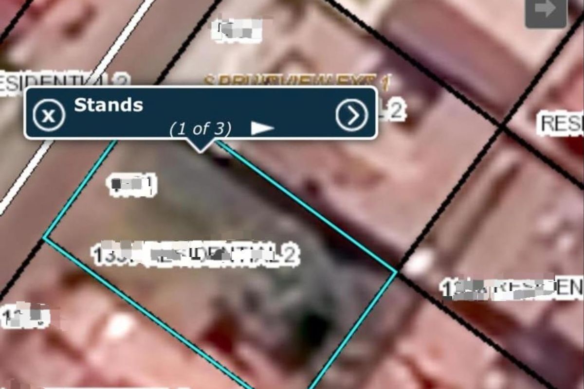 An aerial map view showing the residential land plot boundaries and zoning information.