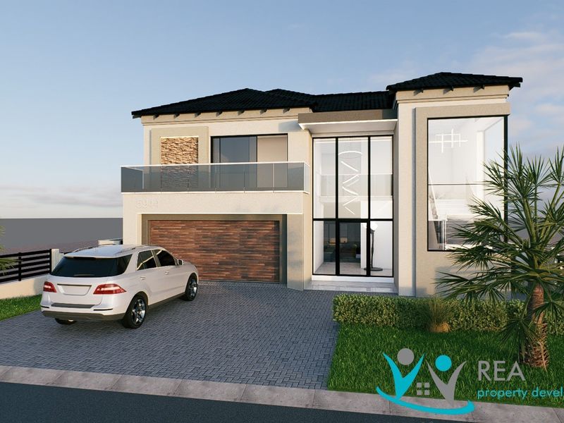 Modern double-story residential facade featuring a paved driveway, double garage, and a prominent glass-fronted entrance with a balcony.