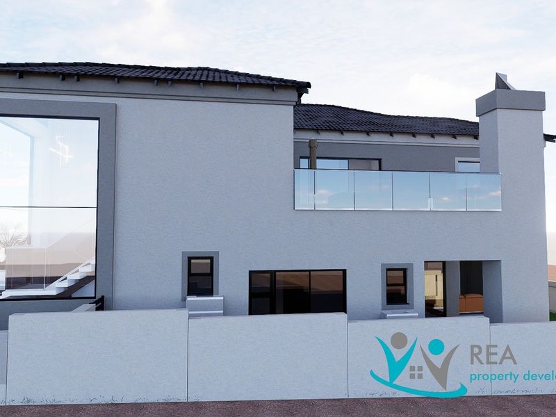 A modern architectural exterior view of the rear facade featuring a glass balcony, tiled roof, and large feature windows.