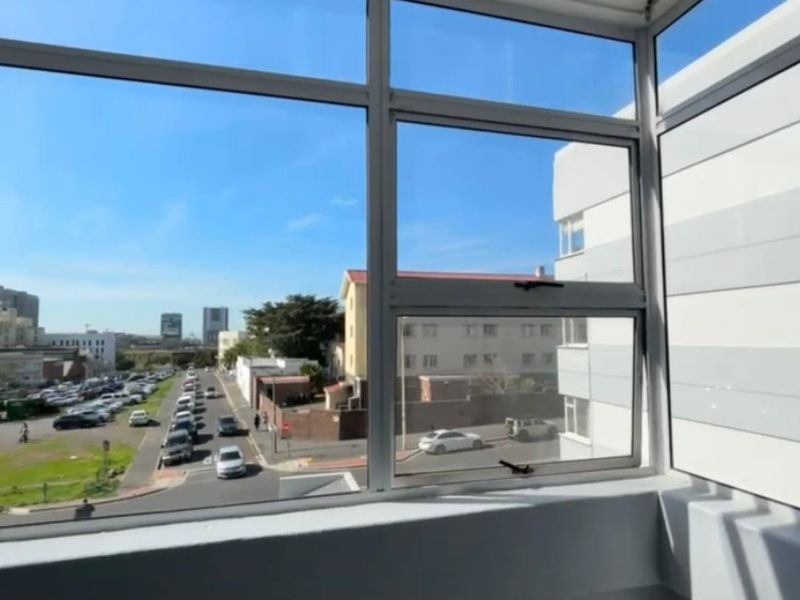 An enclosed balcony area featuring aluminium-framed windows with views overlooking the street and surrounding neighbourhood.