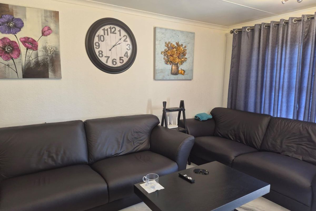 A comfortable living room featuring tiled flooring and classic cove cornicing, providing a neutral foundation for your personal interior design style.