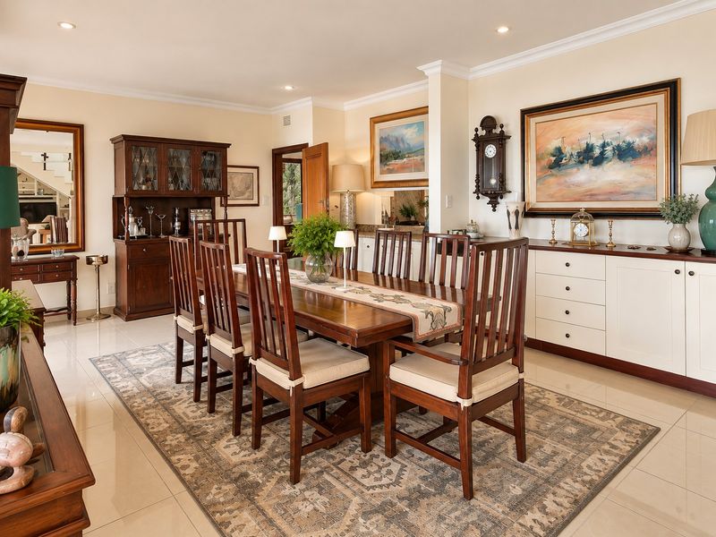 A well-maintained dining room featuring tiled flooring, crown molding, recessed lighting, and custom built-in cabinetry, offering a classic and functional space for entertaining.