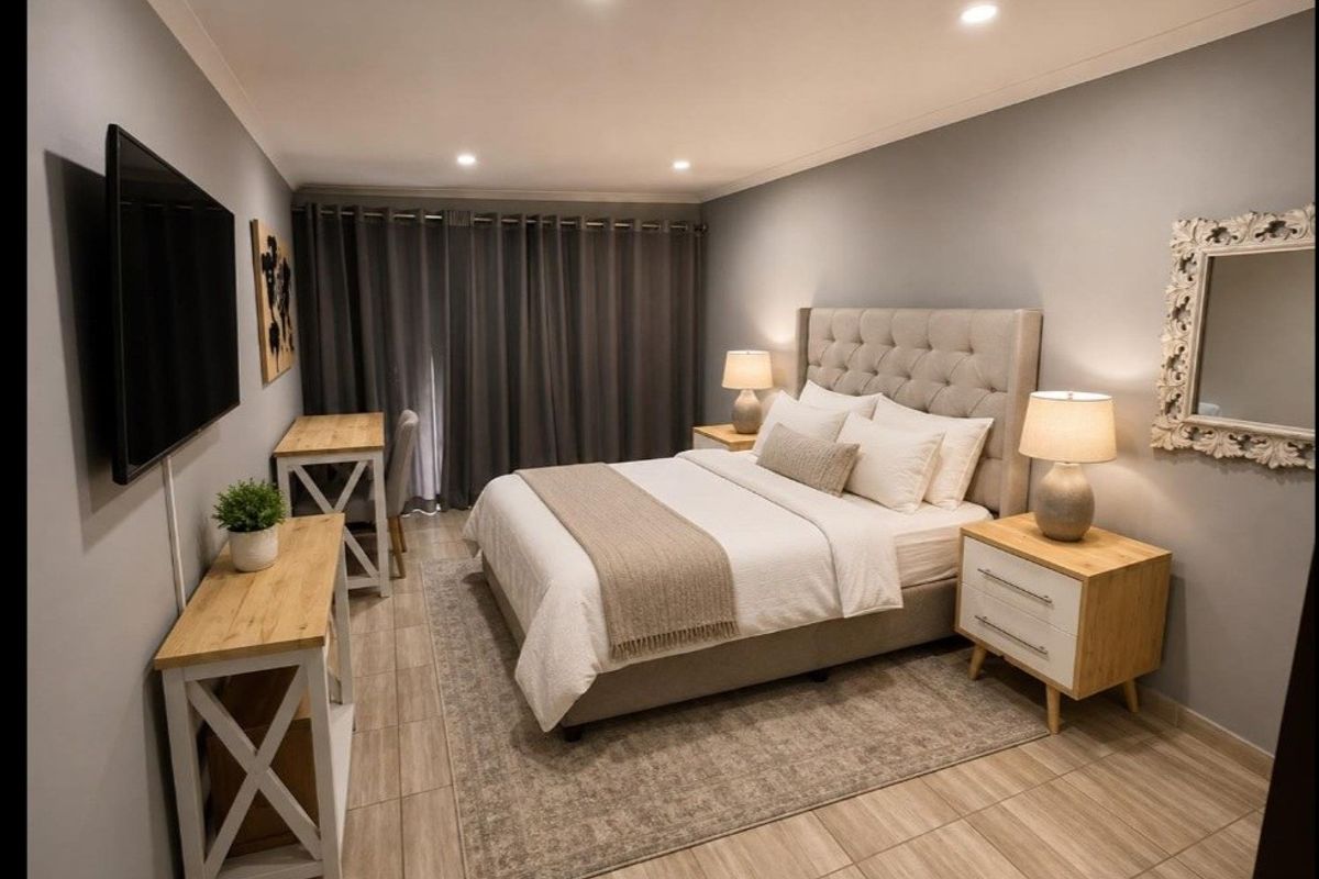 A well-maintained bedroom featuring modern tiled flooring, recessed downlighting, and neutral wall finishes, creating a clean and comfortable living space.