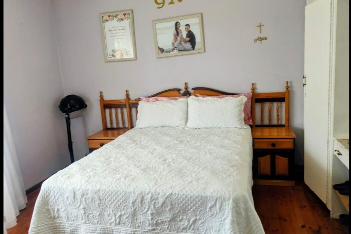 A standard bedroom featuring timber flooring and neutral wall finishes, providing a functional space for rest.