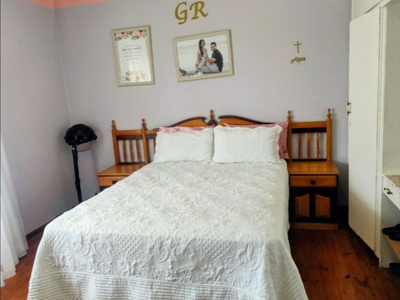 A standard bedroom featuring timber flooring and neutral wall finishes, providing a functional space for rest.