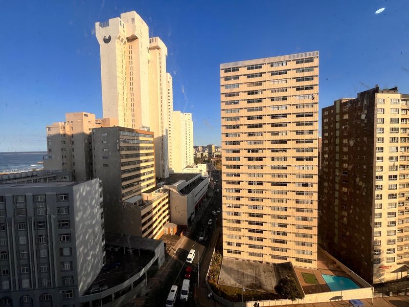 An elevated urban view overlooking surrounding high-rise apartment buildings and city streets.