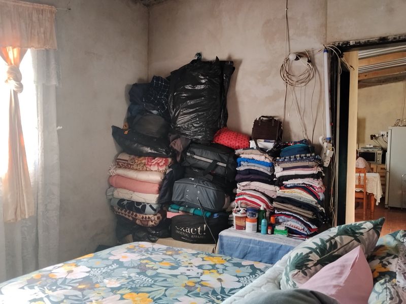 A bedroom featuring unfinished wall surfaces and exposed electrical wiring, requiring cosmetic updates and electrical maintenance to improve the living space.