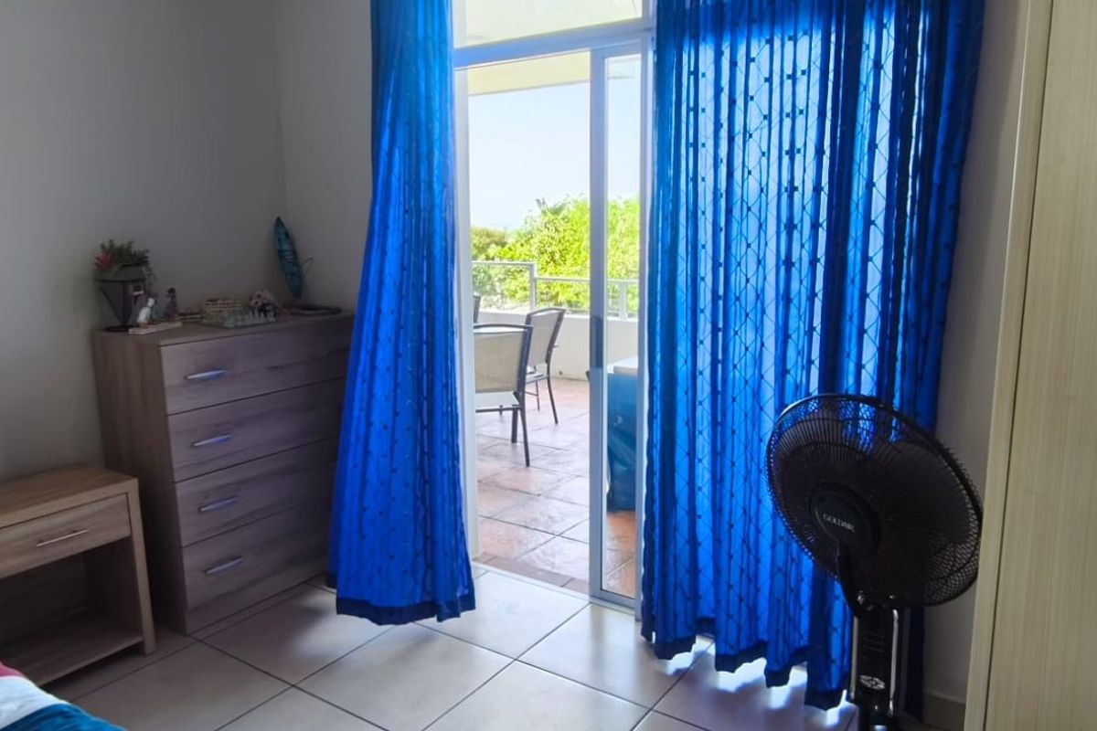 Bedroom featuring tiled flooring and a sliding glass door providing direct access to an outdoor balcony area.