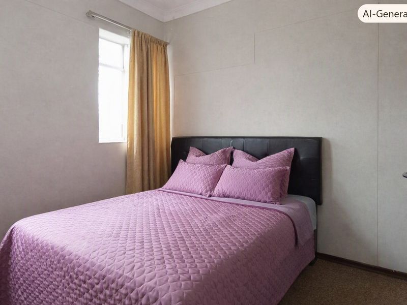A standard bedroom featuring carpeted flooring, a window with curtain rod, and a door.
