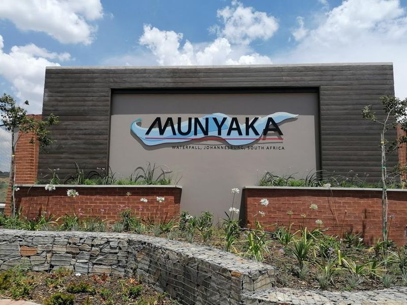 The entrance signage and landscaped frontage of the Munyaka residential development in Waterfall, Johannesburg.