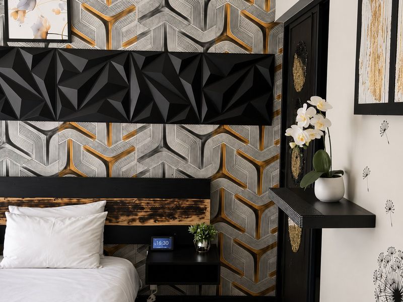 A modern bedroom featuring bold geometric wallpaper, a textured 3D accent wall panel, and a sleek floating bedside table.