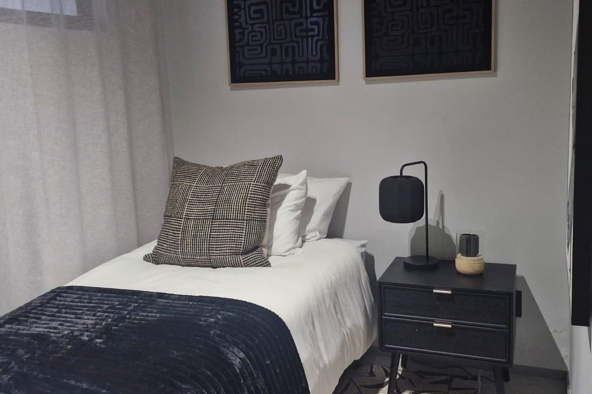 A well-presented bedroom featuring neutral wall tones and modern finishes, creating a comfortable and inviting sleeping space.