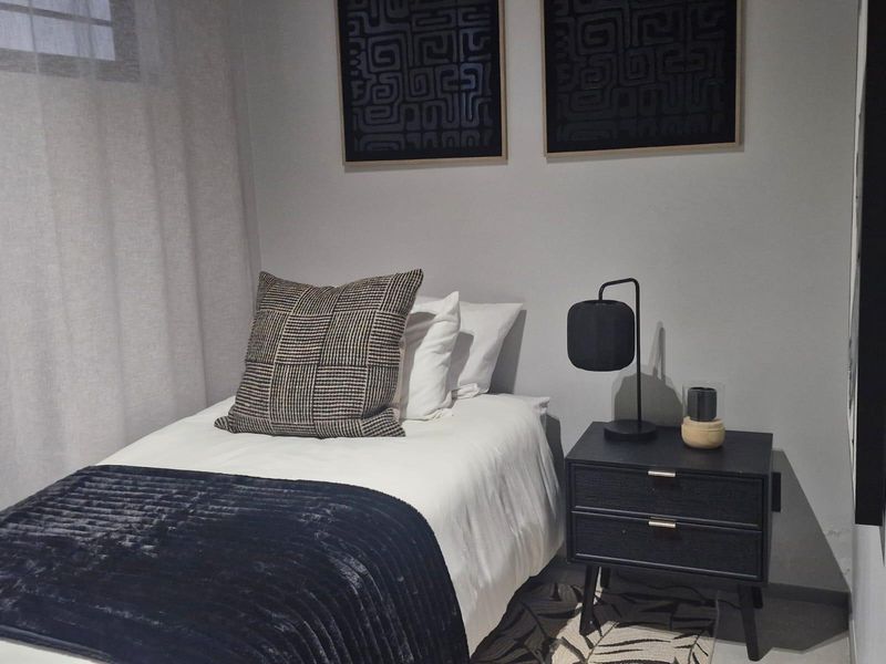 A well-presented bedroom featuring neutral wall tones and modern finishes, creating a comfortable and inviting sleeping space.