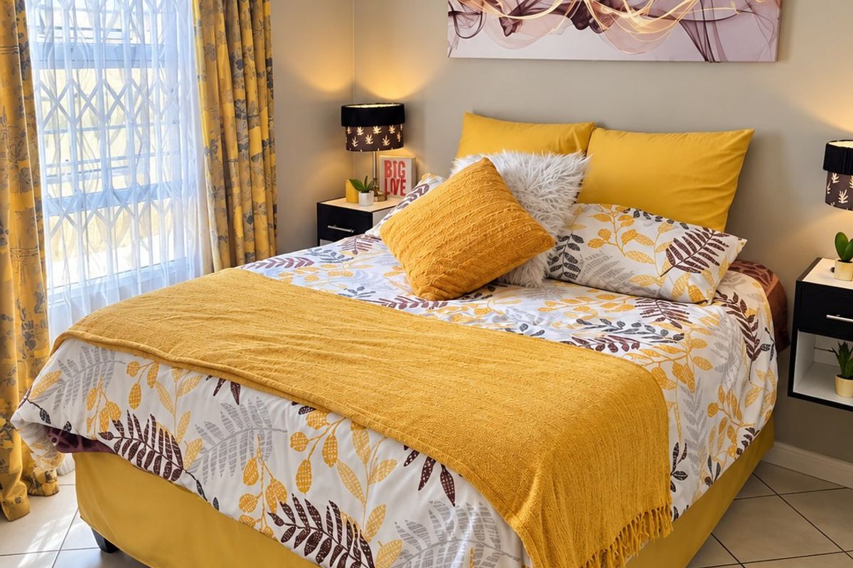 A well-maintained bedroom featuring tiled flooring, a window with a security gate, and built-in bedside tables.