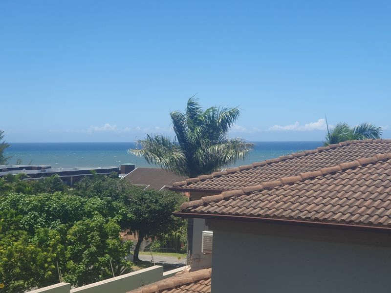 An elevated view overlooking the surrounding neighborhood with a clear sightline to the ocean.